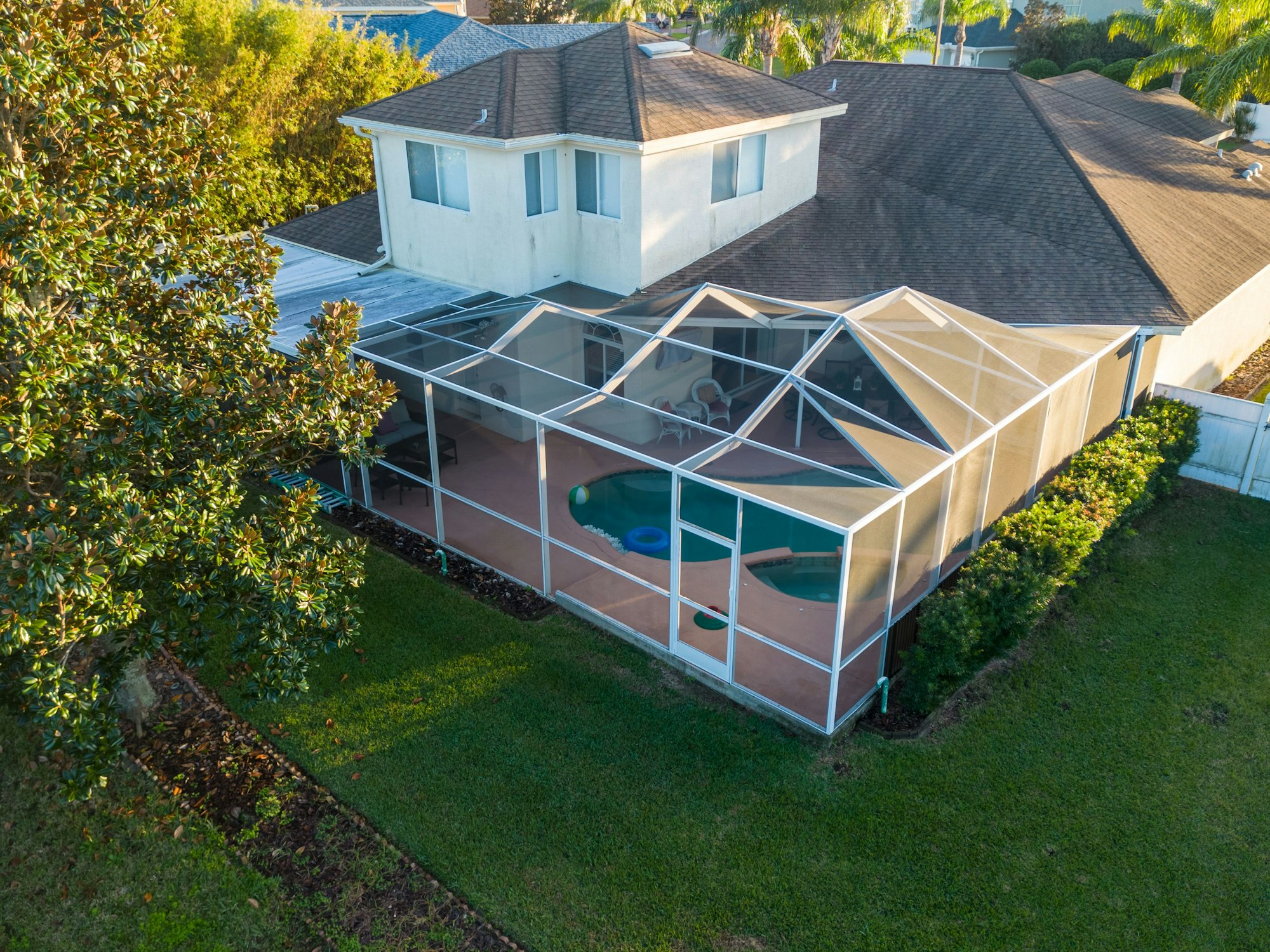 Aerial view of pool screen enclosure surrounded by trees
